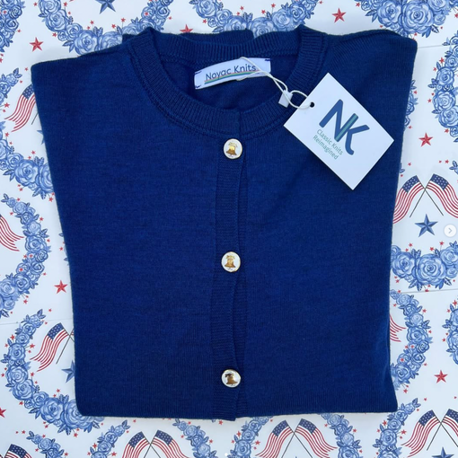Noyac Knits cobalt blue merino cardigan with vintage Liberty Bell buttons, debuting at the Sag Harbor Arts & Crafts Fair 2026.