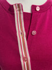 Close up of Noyac Knits Grace classic cardigan in beautiful raspberry pink with signature ribbon trim and pink buttons -- knit in lightweight premium merino