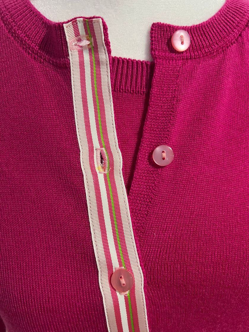  Close up of Noyac Knits Grace classic cardigan in beautiful raspberry pink with signature ribbon trim and pink buttons -- knit in lightweight premium merino