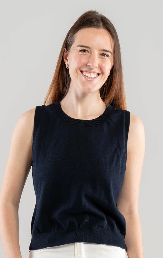 Woman wearing a Noyac Knits navy crew neck class sleeveless shell against a plain background