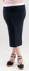 Woman wearing a Noyac Knits navy ribbed knit midi skirt and navy espadrilles on a white background