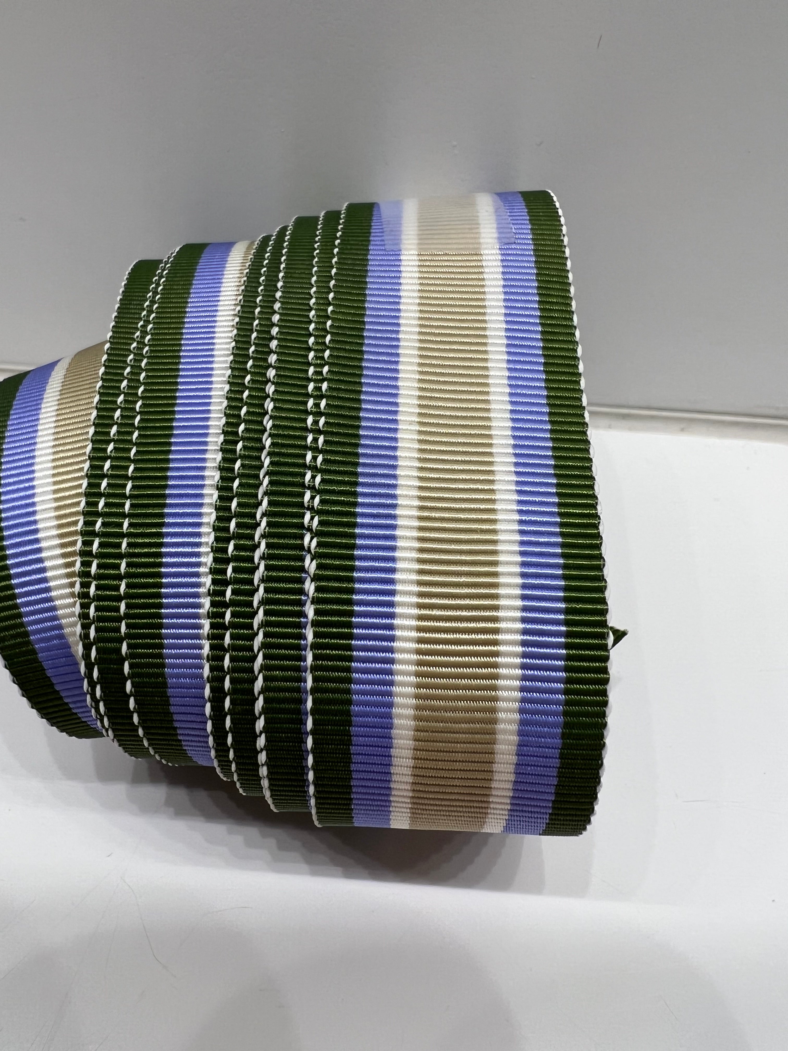 Close up of grostrain ribbon with army green, blue, white and tan stripes