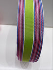 Close up of pink, green, lavender, blue and white striped ribbon on Pamela sweaters on a white background