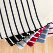 Stack of Noyac Knits Breton striped square neck tanks on a wooden surface