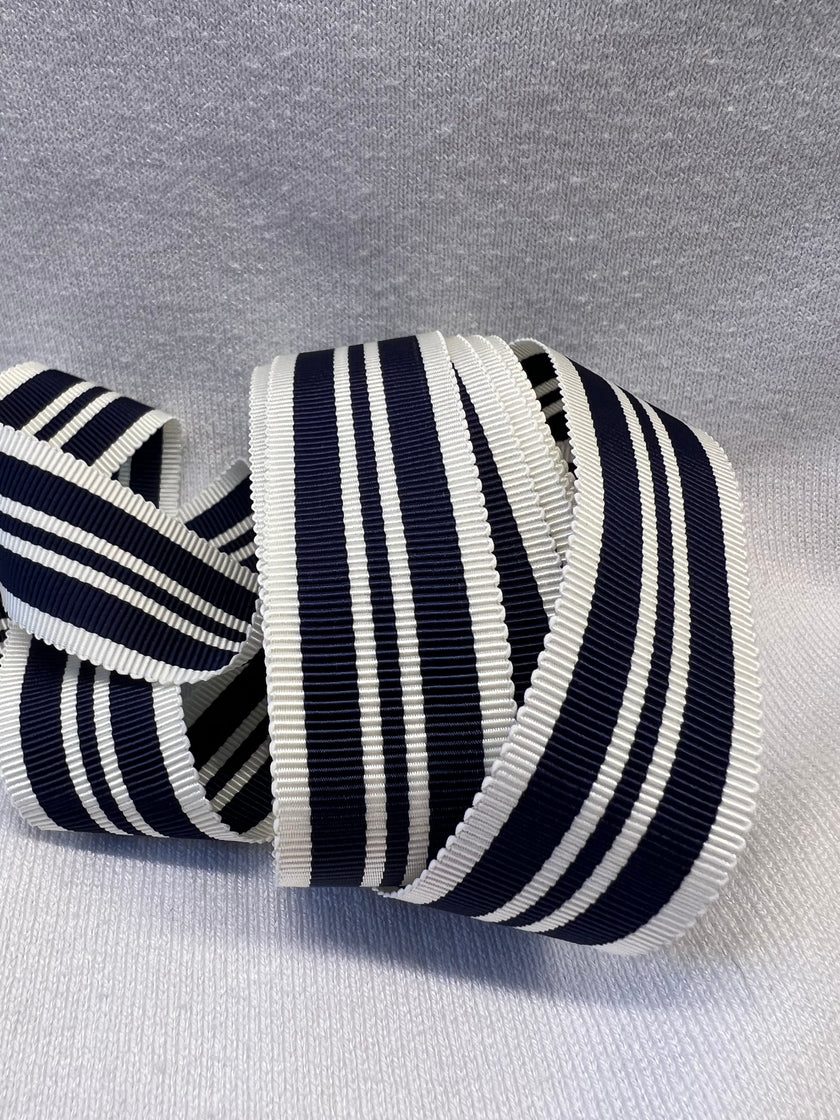 Navy and white striped ribbon on a lightwhite background