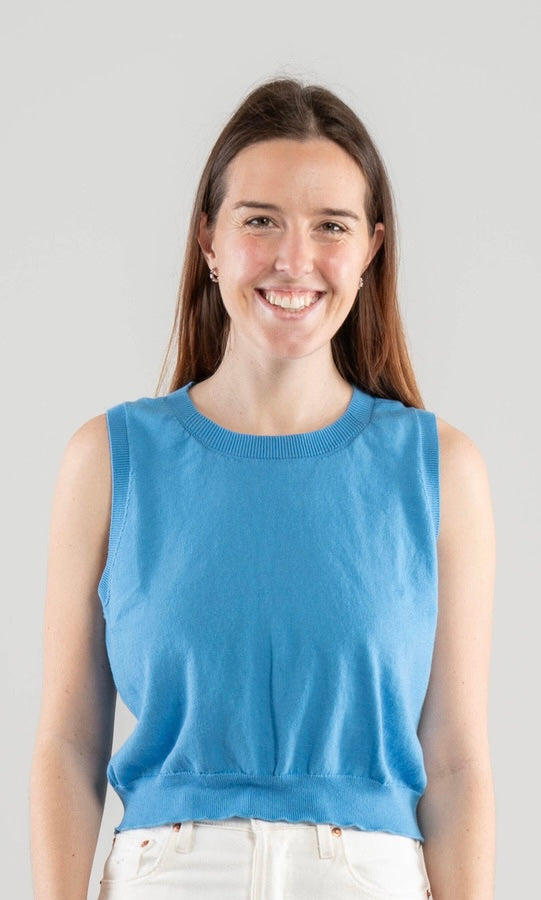 Woman wearing a Noyac Knits sky blue sleeveless top with crew neck in lightweight cotton against a plain background