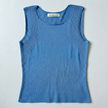 Flat lay photo of Noyac Knits featherweight scoopneck tank with traveling rib pattern around arms in lightweight environmentally sustainable ecoviscose in light blue