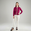 Woman wearing Noyac Knits Grace classic cardigan in beautiful raspberry pink with signature ribbon trim and pink buttons -- knit in lightweight premium merino -- styled with white jeans and espadrilles on a gray background