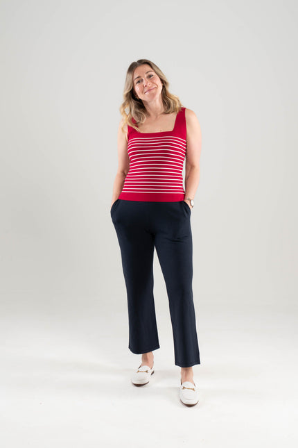 Woman wearing Noyack Knits Breton square neck tank in red with white stripes and navy stretch knit ankle length pants, both in environmentally sustainable ecoviscose on a white background 