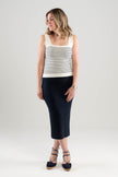 Woman wearing a Noyac Knitsw white and navy striped square necl tank top and navy midi ribbed pencil skirt styled with navy espadrilles on a plain background