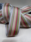Close up of grosgrain ribbon with pastel stripes of baby blue, light pink, mint green, light tan, dark pink, and tan on plain background.