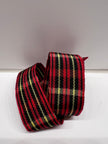 Close-up of red, black and gold tartan plaid grosgrain ribbon on plain background.