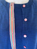 Blue cardigan with pink buttons and a rainbow-striped stripe ribbon on a white background