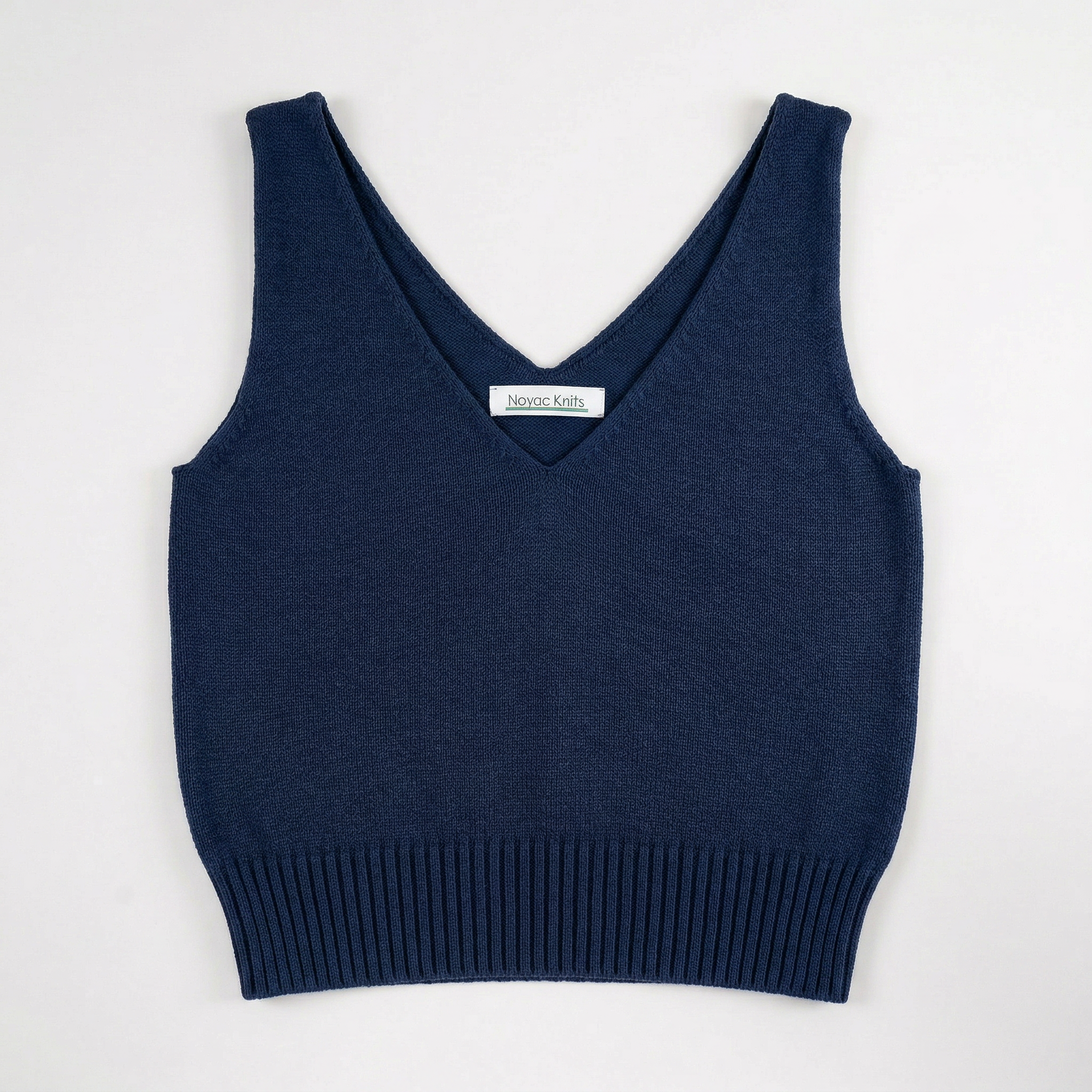 Lay flat photo of Noyac Knits navy blue double v-neck crop tank made in lightweight, soft cotton on white background