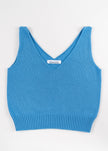 Lay flat photo of Noyac Knits light blue double v-neck crop tank made in lightweight, soft cotton on white background