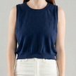 Woman wearing a Noyac Knits navy blue crew neck sleeveless shell in lightweight cotton against a white background