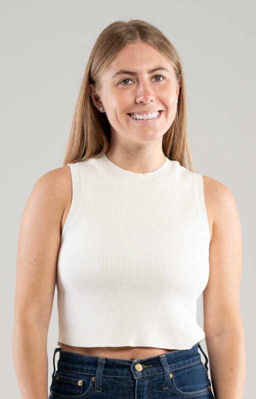 Woman wearing a Noyac Knits white sleeveless crew neck crop tank in environmentally sustainable ecoviscose on white background