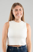 Woman wearing a Noyac Knits white sleeveless crew neck crop tank in environmentally sustainable ecoviscose on white background