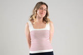 Woman wearing a Noyac Knits white square neck striped tank top with red stripes in machine washable ecoviscose on a plain background