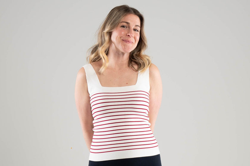 Woman wearing a Noyac Knits white square neck striped tank top with red stripes in machine washable ecoviscose on a plain background